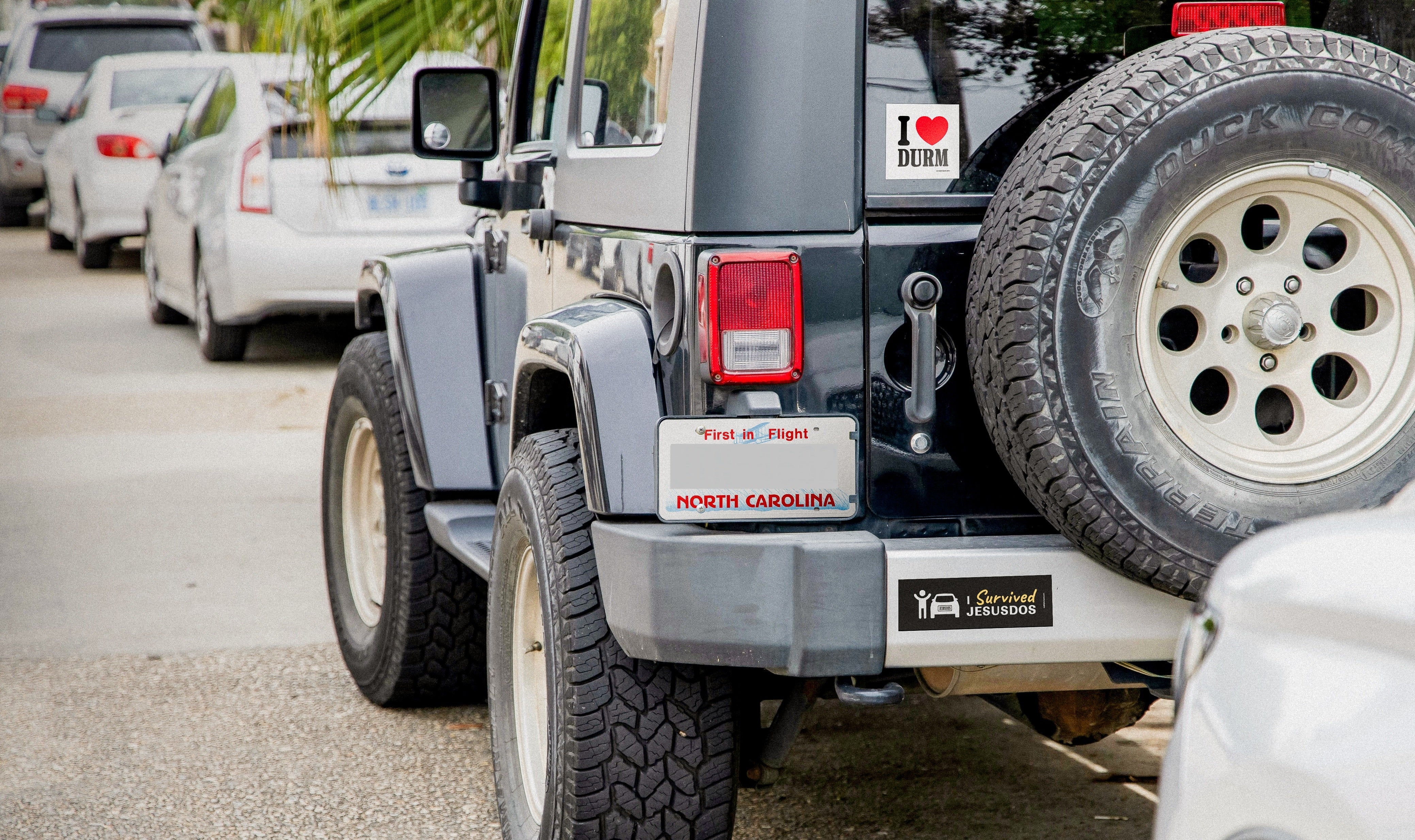 Authentic black Jeep tailgate in North Carolina with Durham bumper stickers